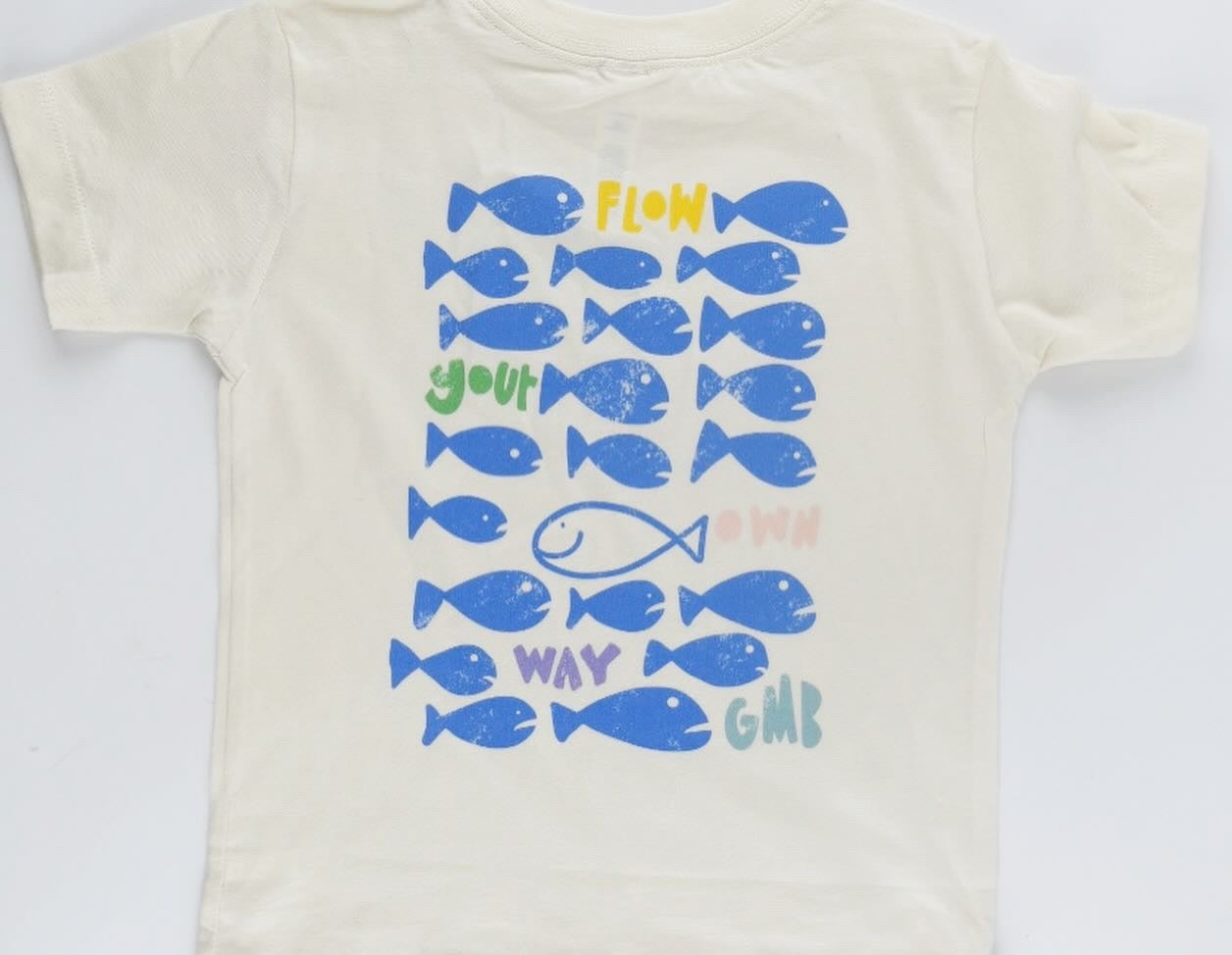 Kids graphic tee with school of fish and one swimming opposite direction