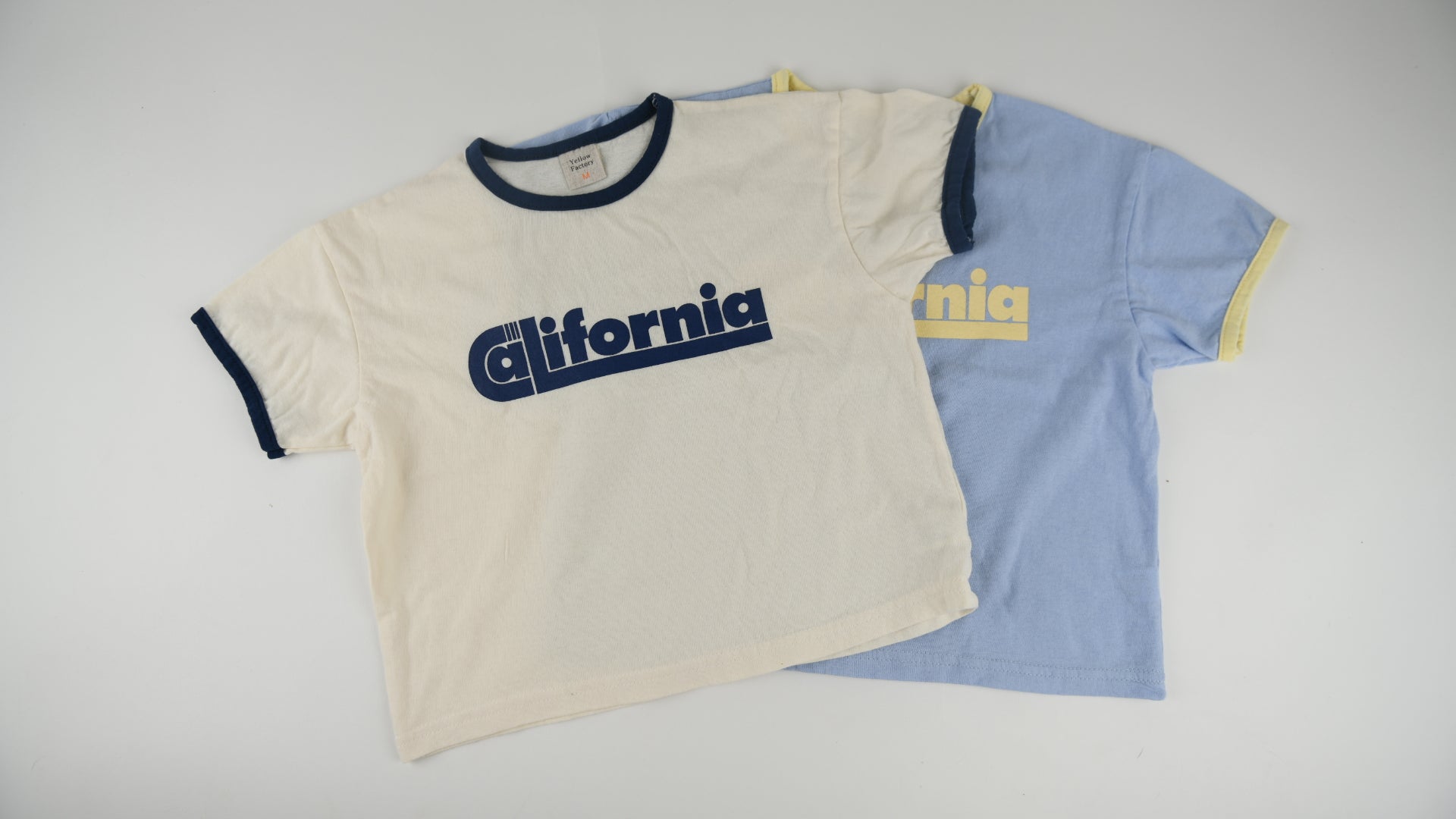 Flat lay of unisex kids California t-shirt in blue and white